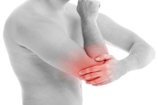 Man is touching his back because it aches